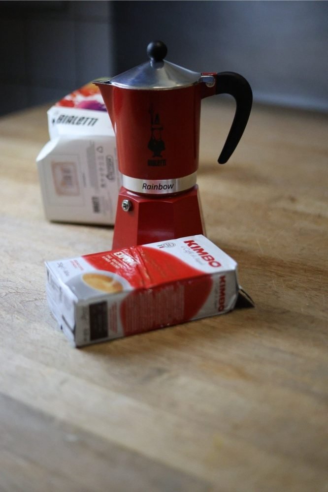 An Italian moka pot and coffee on the counter